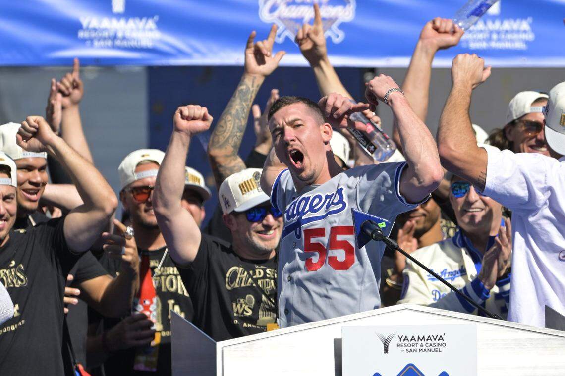 Nov 1, 2024; Los Angeles, CA, USA;  Los Angeles Dodgers starting pitcher Walker Buehler (21) speaks to fans during the World Series Championship Celebration at Dodger Stadium. Mandatory Credit: Jayne Kamin-Oncea-Imagn Images