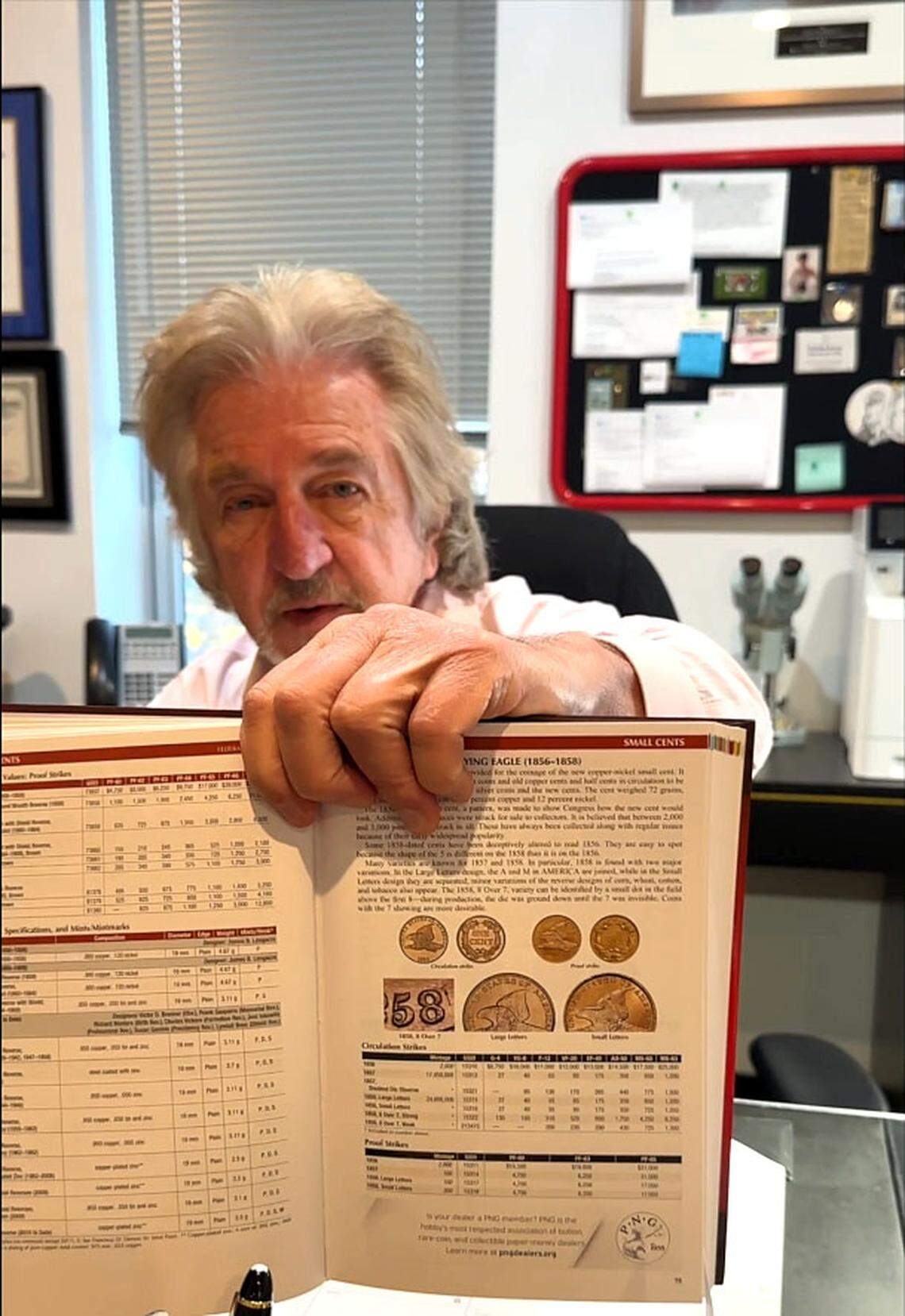 Jeff Garrett, considered one of the nation’s top experts in US coinage, holds a copy of “A Guide Book of United States Coins,” Tuesday, Nov. 18, 2025, in his office at Mid-American Rare Coin Galleries in Lexington, Ky. Commonly called the “Red Book,” the annual reference guide for coin collectors is in its 79th edition with Garrett being the Senior Editor since 2019.