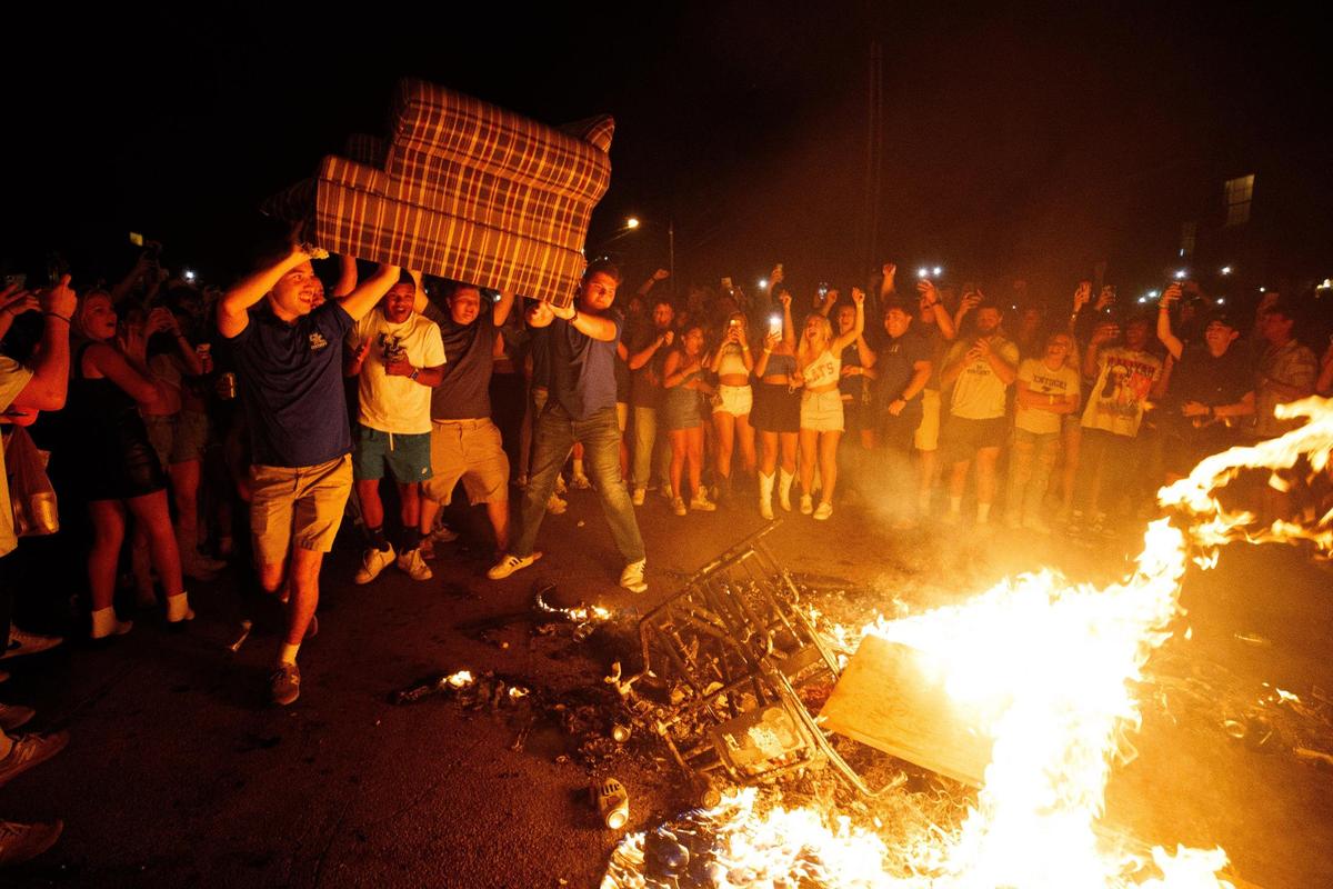 A couch is thrown into a fire on State Street in Lexington, Kentucky after Kentucky football’s 26-16 win at Florida on Saturday, Sept. 10, 2022.