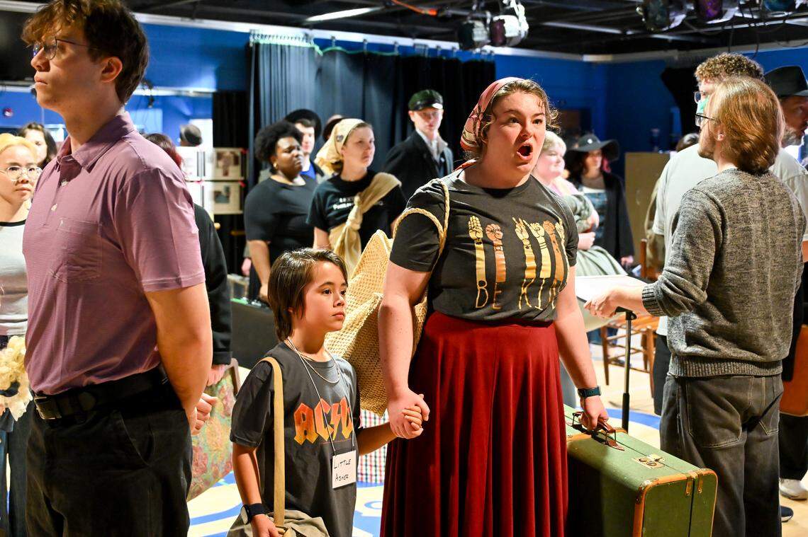 Fairynne Rogers (right) portrays a mother trying to immigrate to the United States with her son, played by Asher Fitzgerald (left). The University of Kentucky Opera Theatre presents the world premiere of "A Nation of Others," an opera by Paul Moravec with a libretto by Mark Campbell. This photo was taken at a rehearsal February 28, 2026 in the Schmidt Vocal Arts Center on the University of Kentucky Campus in Lexington, Kentucky.