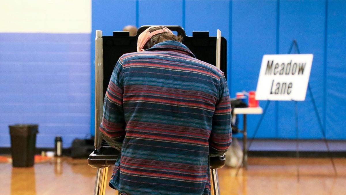 A voter cats their ballots for the 2023 statewide general election at the Meadow Lane precinct at Yates Elementary School, Tuesday, November 7, 2023 in Lexington, Ky.