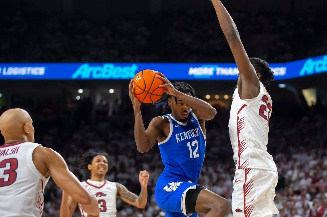 Kentucky guard Antonio Reeves (12) drives the ball as Arkansas forward Makhel Mitchell (22) defends during Saturday’s game at Bud Walton Arena in Fayetteville, Ark.