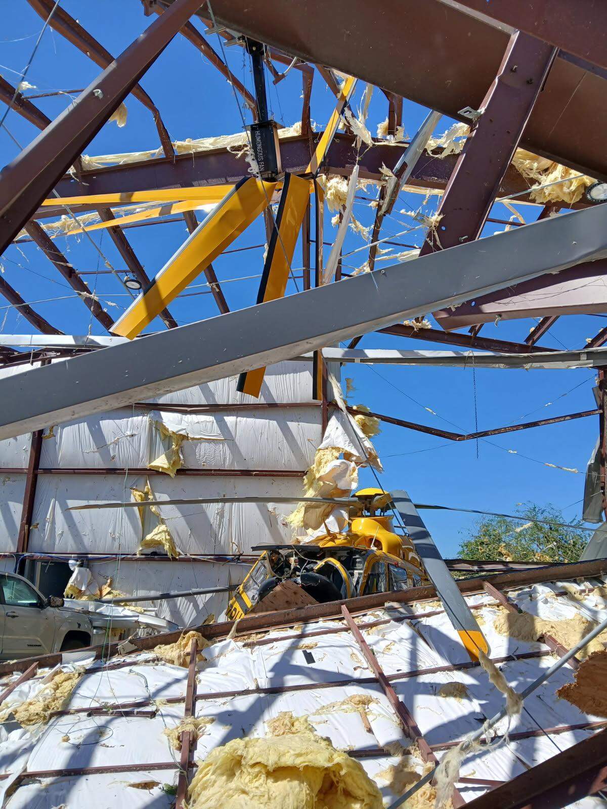 A wrecked PHI medical helicopter was inside a collapsed hanger at the London-Corbin Airport after severe overnight storms and a presumed tornado Saturday, May 17, 2025.