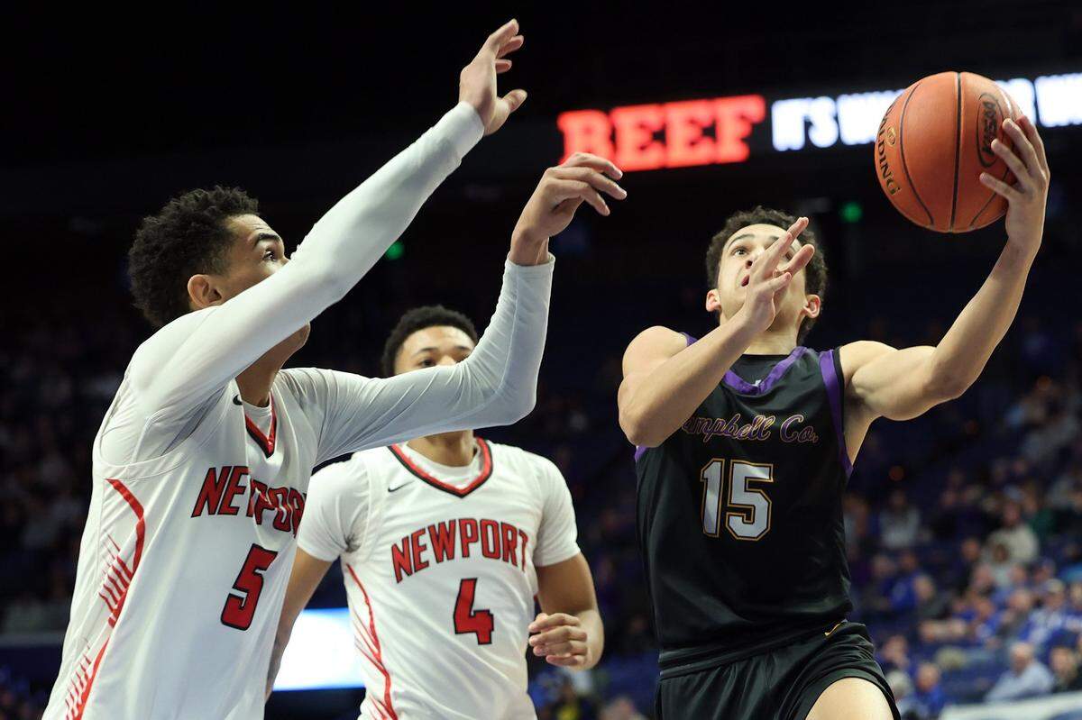 Campbell County’s Garyn Jackson (15) challenges Newport’s James Turner (4) and Griffin Starks (5). Jackson finished with 11 points, six rebounds and four assists for the Camels.