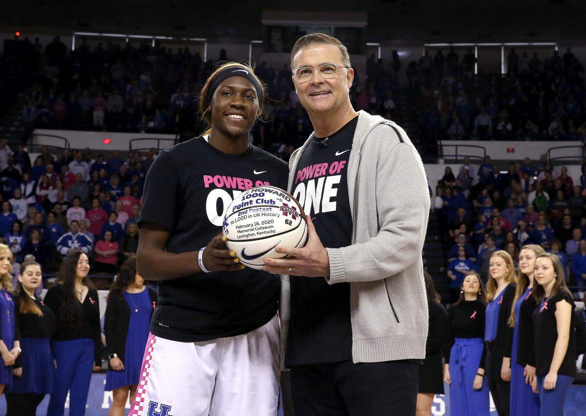 Former Kentucky head coach Matthew Mitchell presented a basketball to Rhyne Howard last season to commemorate her joining UK’s 1,000 career points club.