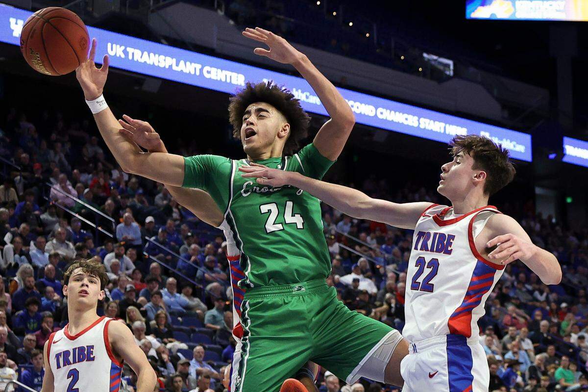 Great Crossing senior Malachi Moreno and Montgomery County freshman Andrew Terry reach for the ball during the Boys’ Sweet 16 semifinals at Rupp Arena on Saturday.