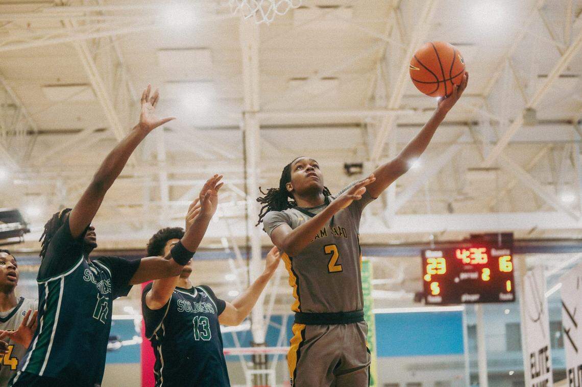 Team Thad's Jasper Johnson (2) lays the ball up against Team Oak Soldiers' Doug Langford (13) during the Nike Elite Youth Basketball League session one on Saturday, April 27, 2024 at the Memphis Sports & Event Center in Memphis, Tenn.