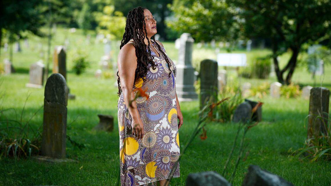 Sarah Williams, of Lexington, Ky., stands near headstones in African Cemetery No. 2 on East 7th Street in Lexington, Thursday, July 22, 2021.