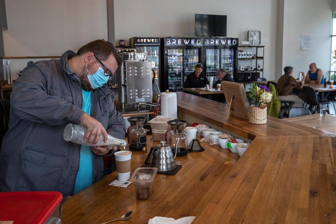 Andrew Cooperrider, owner at Brewed in Lexington, Ky., makes a drink on Tuesday, Nov. 24, 2020. Earlier in the day, the Lexington-Fayette County Health Department had ordered the establishment closed.