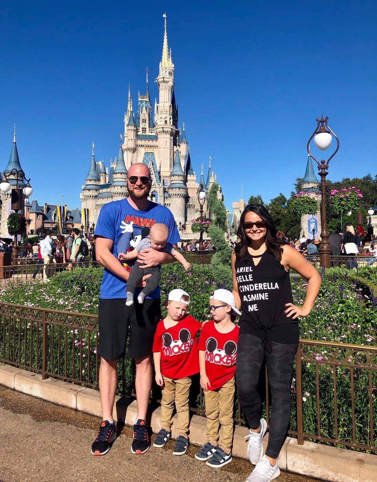 Dakotah Euton, left, and his wife, Colby, right, with their three sons -- from left to right, Knox (9 months), Channing (4) and Titus (5) -- at Disney World in Florida.