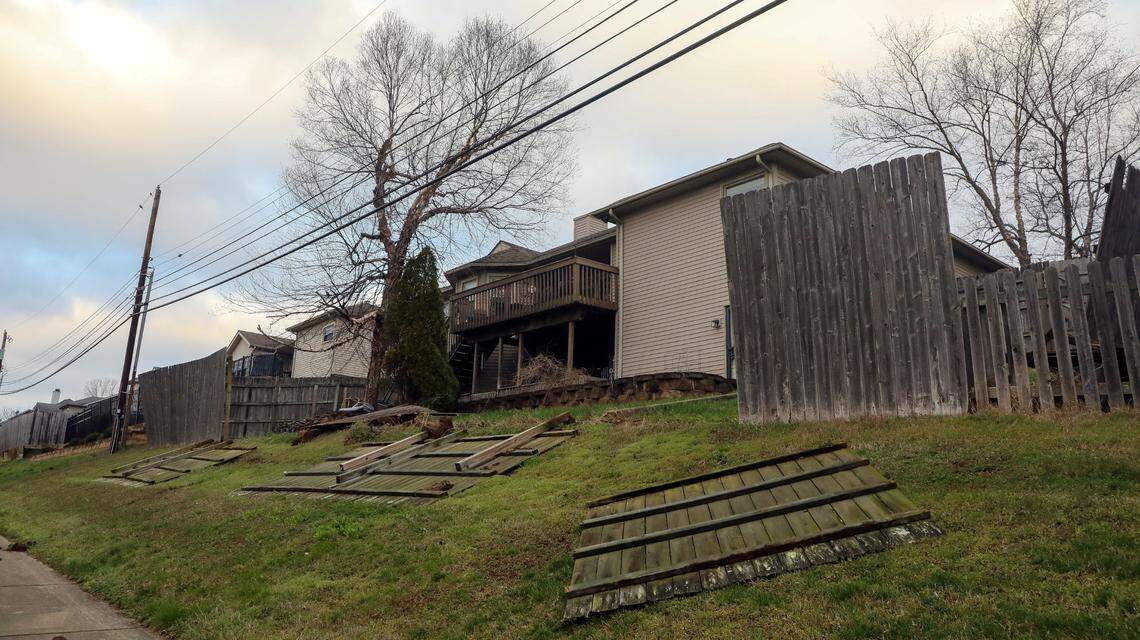 A fence is blown over a neighborhood backyard on Old Higbee Mill Road Saturday, March 4, 2023 after a strong wind storm knocked out power to much of Lexington the night before.