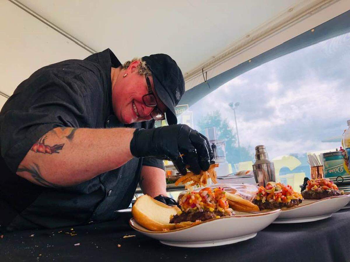 Chef Ranada Riley puts the finishing touches on one of her signature meals