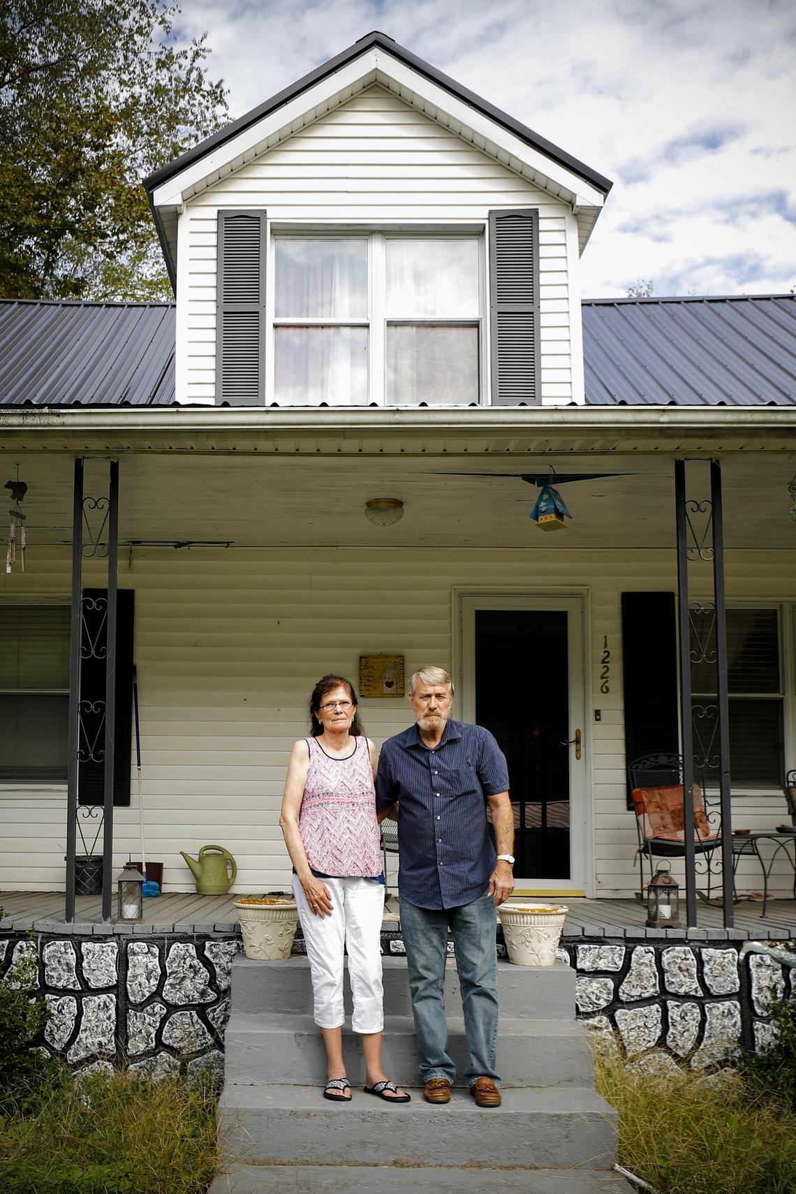 Betty and Calvin Jude, of Inez, stood on the front porch of their home on Tuesday, Oct. 2. Both lifelong residents of Martin County have worried about the county’s water quality for years. The Judes use bottled water for all cooking and drinking and say the water irritates their skin when bathing. Betty was diagnosed with breast cancer in 2011 and believes contaminates in the tap water caused it.