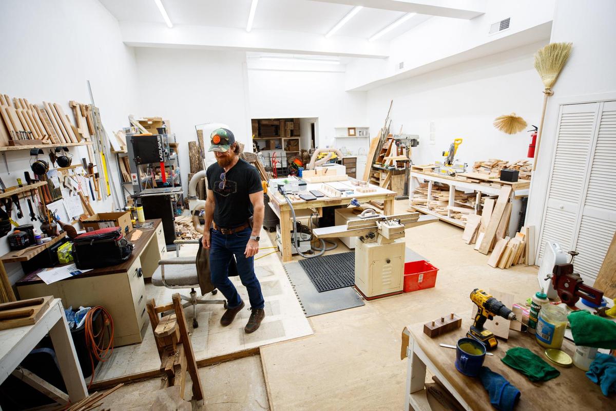 Doug Stubbs walks through his wood shop on Saturday, June 25, 2022, at Sunhouse Craft in Berea. Stubbs makes cutting boards for sale in the shop.
