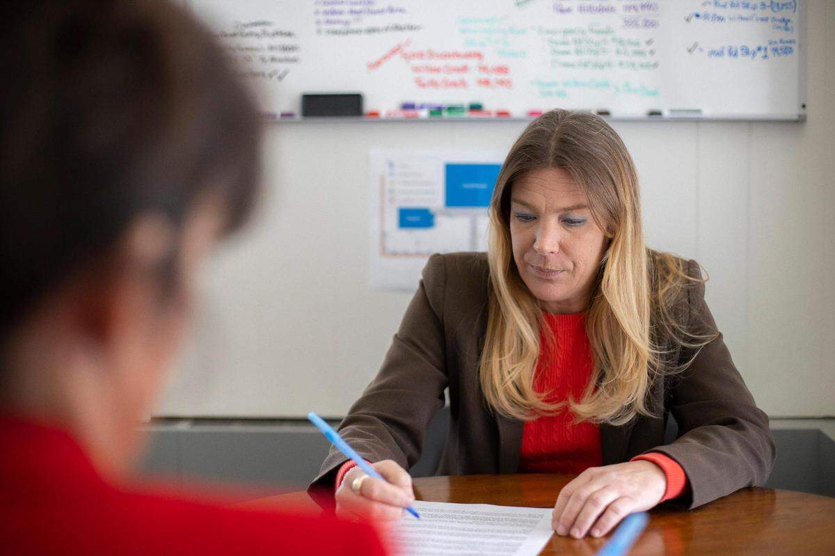Beth Moore, county attorney for Bracken County, goes over paperwork with Judge Executive Tina Teegarden at Teegarden’s office in Brooksville, Ky., on Thursday, March 3, 2022.