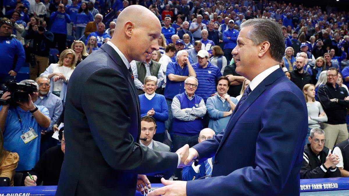 Louisville’s Chris Mack greets Kentucky’s John Calipari before their game in Rupp Arena in 2019. The two schools will try to reschedule their annual rivalry game for later this season.