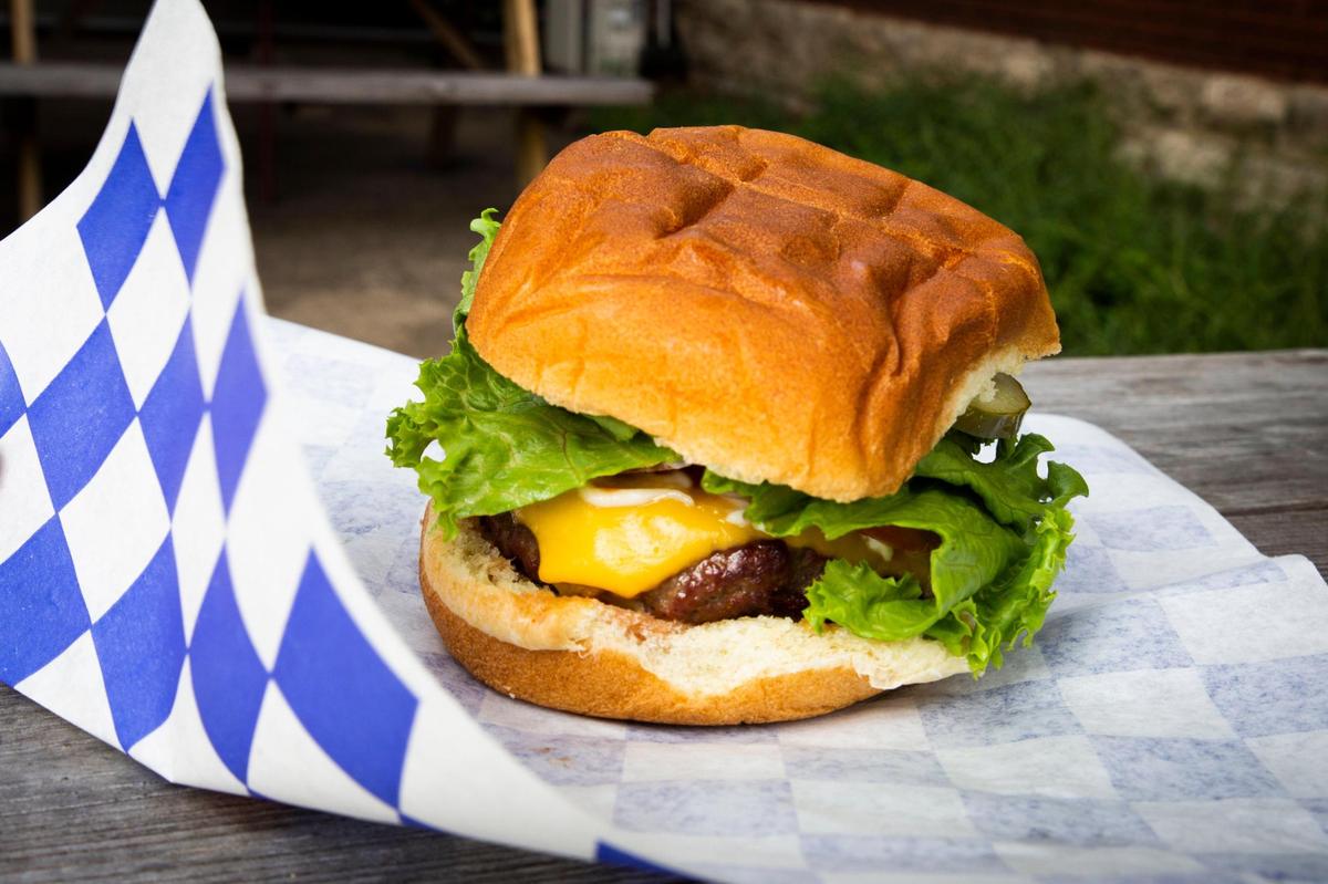 A fully-dressed bacon burger at Wilson’s Grocery, located on Cramer Avenue. The grocery hopes to grill burgers outdoors again this fall.