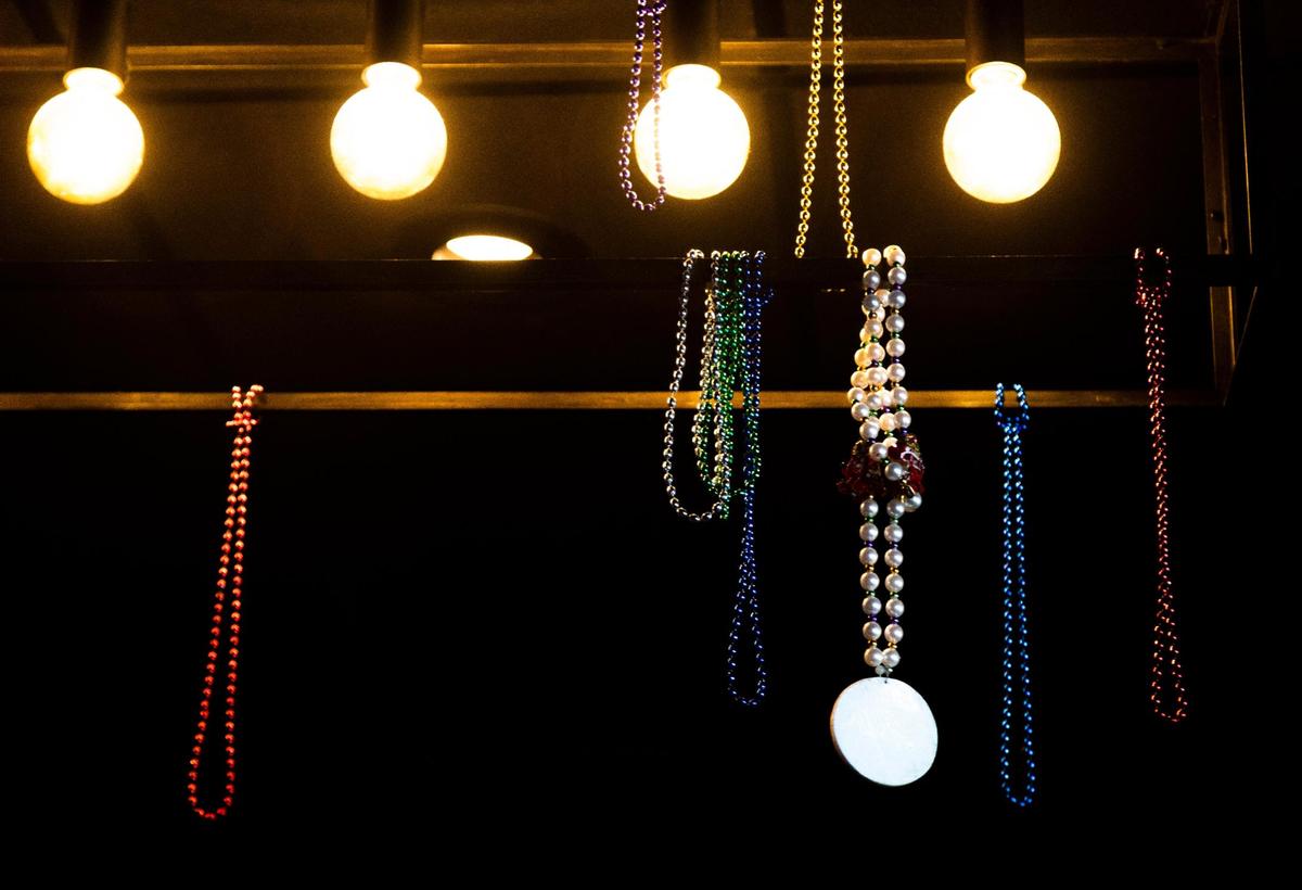 Beads hang from a light fixture above the bar Sept. 30 at Proud Mary BBQ in Lexington.