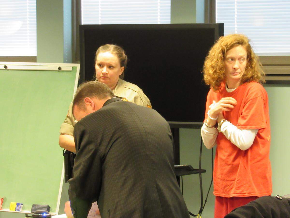 Melissa Wolke, right, prepared to leave court after a hearing in Rockcastle County District Court on Jan. 22, 2020. Defense attorney Nathan Shirley, in the dark suit, represented her. The court security officer is Stacy Thomason.