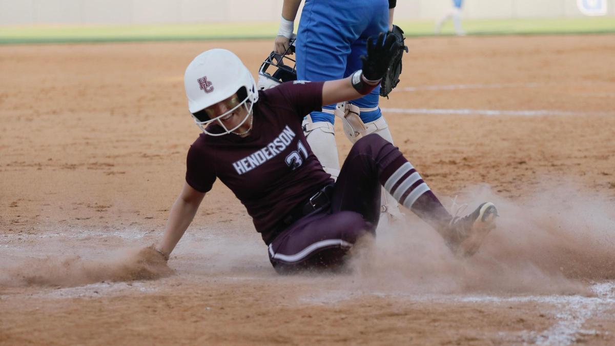 Henderson County left fielder Alyse Rollings scores the go-ahead run in the 10th inning of her team’s 4-1 victory against East Jessamine.
