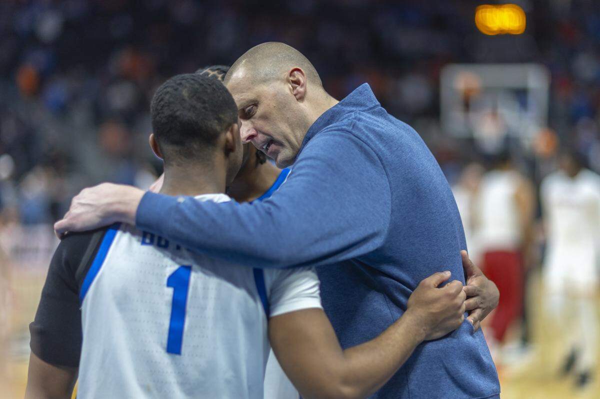 Kentucky head coach Mark Pope talks to Lamont Butler (1) and Otega Oweh following a second-round NCAA Tournament victory against Illinois at Fiserv Forum in Milwaukee on Sunday.