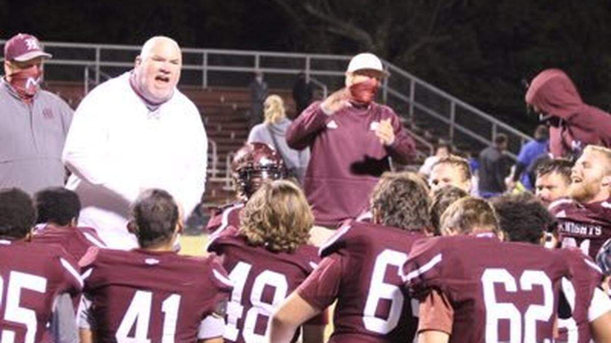 Marion County football coach Rob Reader, left, shown talking to his team after a game from a photo on his Twitter page, has died of cancer at the age of 50.
