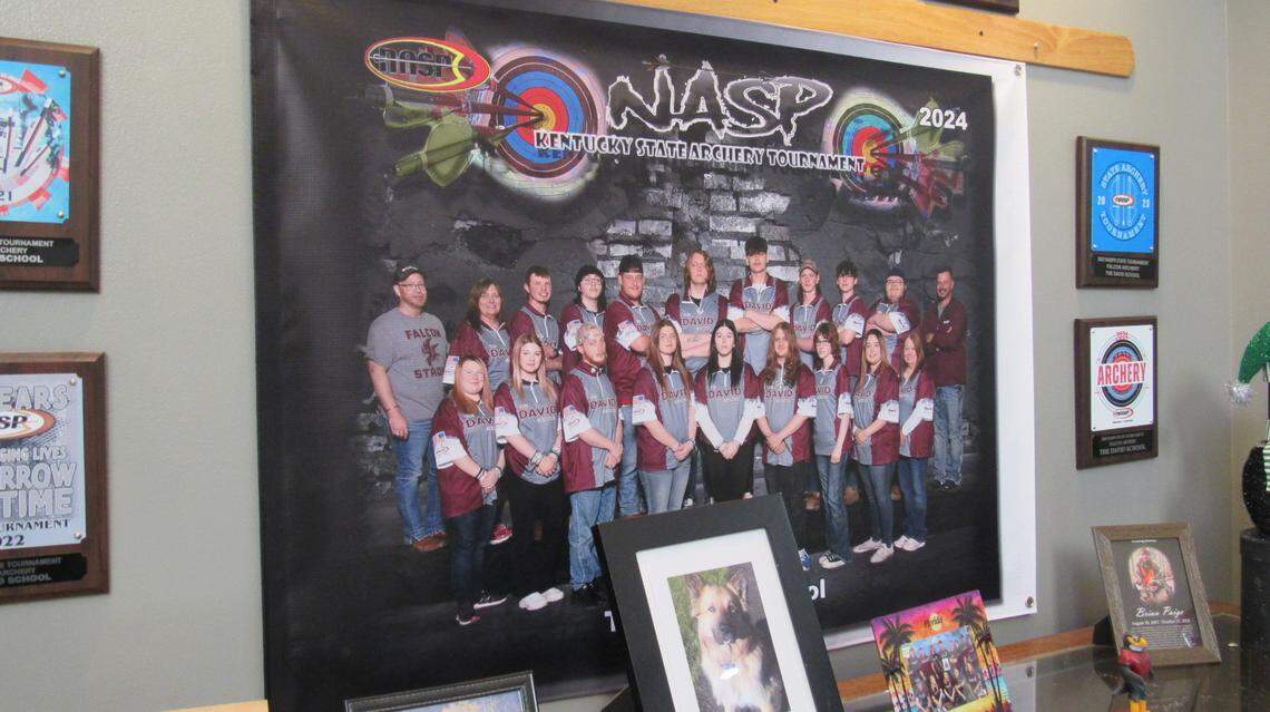 A display in the foyer of the David School includes a poster of the school’s archery team and photo of Wiley, a mixed-breed dog who lived at the school until he died.