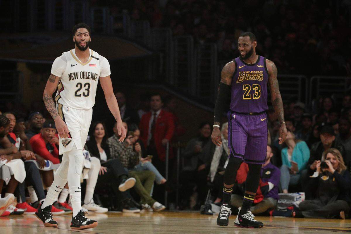The Pelicans’ Anthony Davis, left, and the Lakers’ LeBron James shared a light moment during the first half Friday night in Los Angeles.