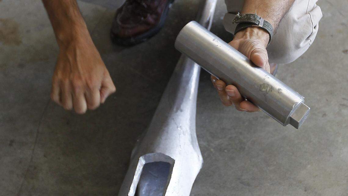 On Aug. 12, artist Douwe Blumberg held a canister containing items from family members of one of the victims as he partially assembled the sculpture. Each bird in the Flight 5191 Memorial has space for mementos.