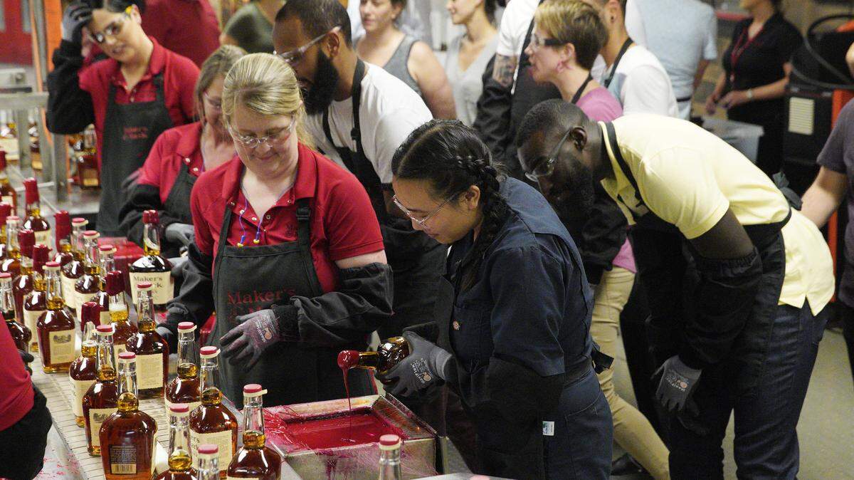 “Top Chef” contestants Nini Nguyen and Eric Adjepong take a dip into bourbon at Maker’s Mark Distillery in Loretto for the elimination challenge of the second episode of the Kentucky season, “Bourbon, Barrels and Burgoo.”