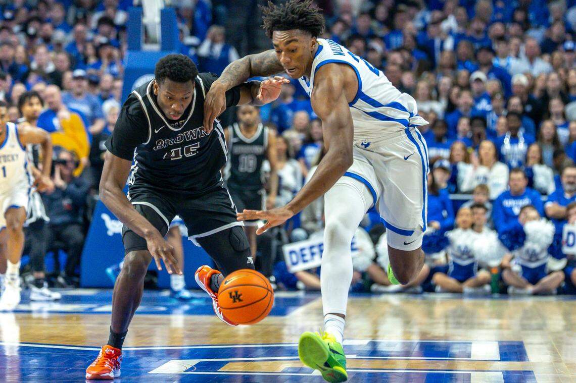 Brown forward N’famara Dabo (45) and Kentucky center Amari Williams (22) battle for control of the ball during Tuesday’s game at Rupp Arena.