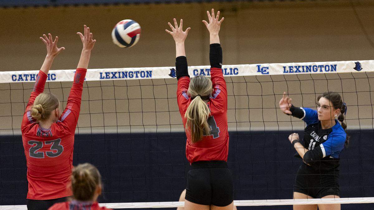 Lexington Catholic’s Ella Blackburn (11) delivered a kill past the defense of West Jessamine’s Kaylee Rexroad-Hardin (23) and Taylor Snowden (14) during the Knights’ 3-0 win at Lexington Catholic High School on Thursday.