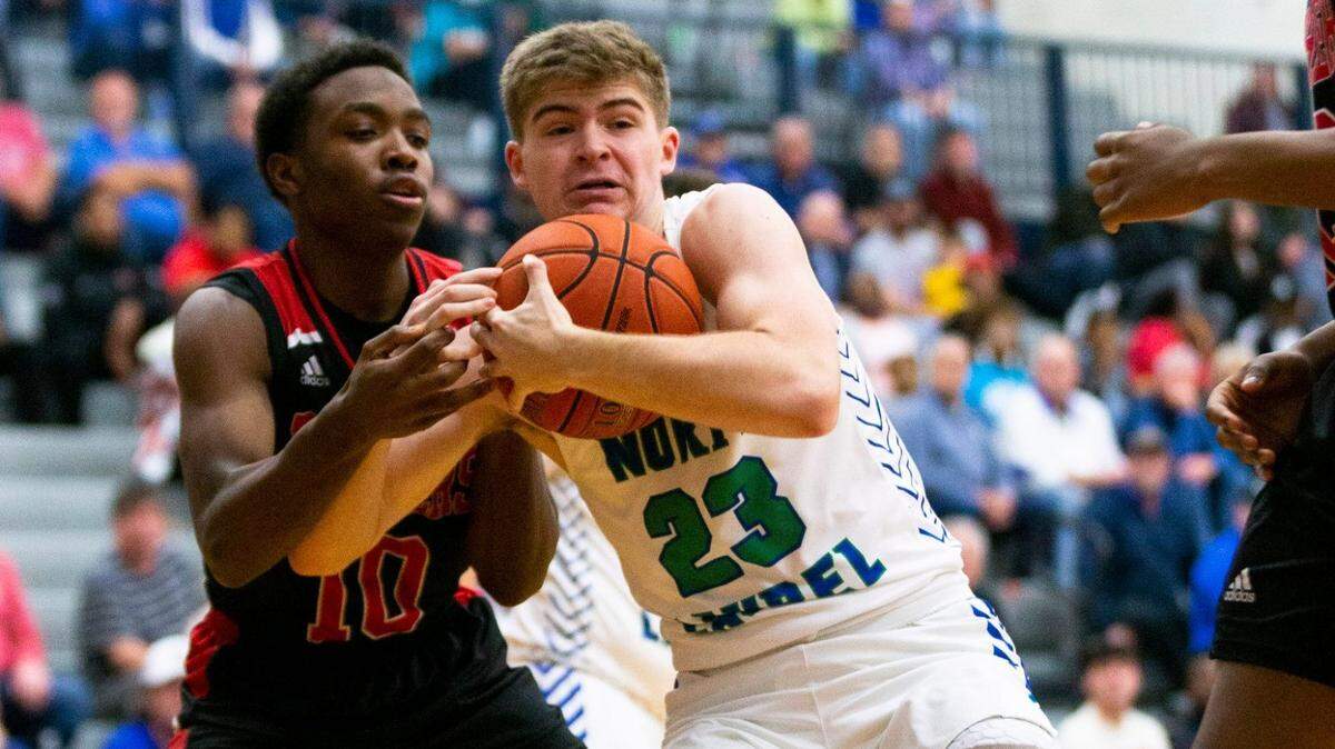 North Laurel’s Brody Brock (23) battled Pleasure Ridge Park’s Gregory Cole (10) for the rebound at the WGM Holiday Classic Tournament at Lexington Catholic High School on Dec. 27, 2021.