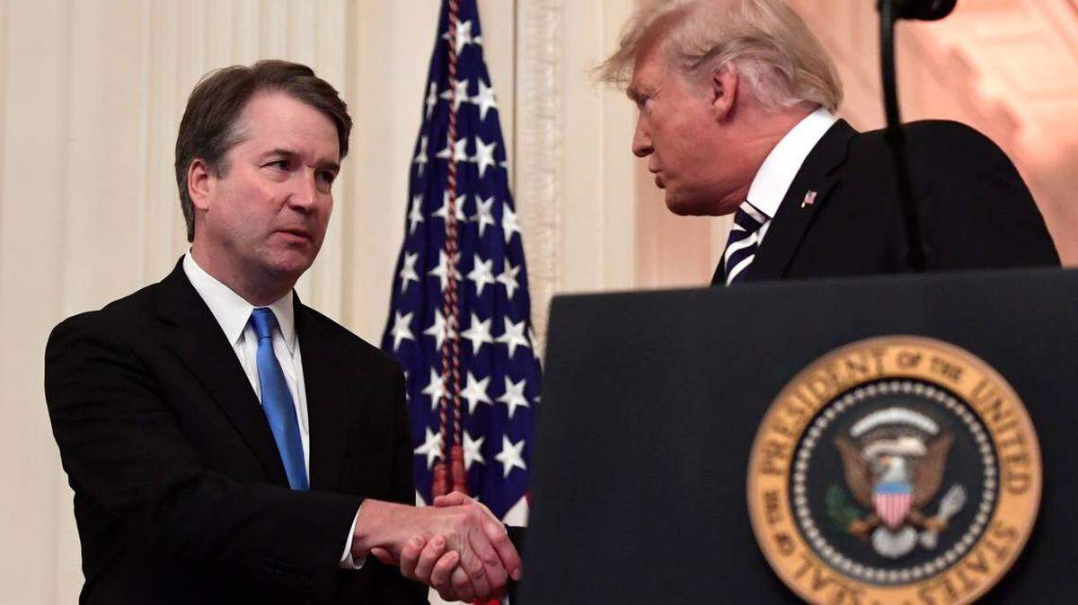 President Donald Trump, right, shakes hands with Supreme Court Justice Brett Kavanaugh, left, before a ceremonial swearing in in the East Room of the White House in Washington, Monday, Oct. 8, 2018. SUSAN WALSH AP