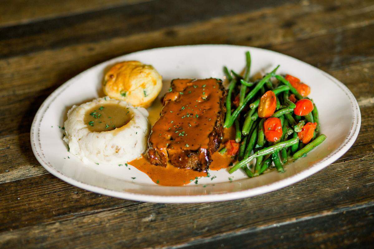 The Homestyle Meatloaf for $20 at Nic & Norman’s comes with mashed potatoes, gravy, green beans and cornbread.