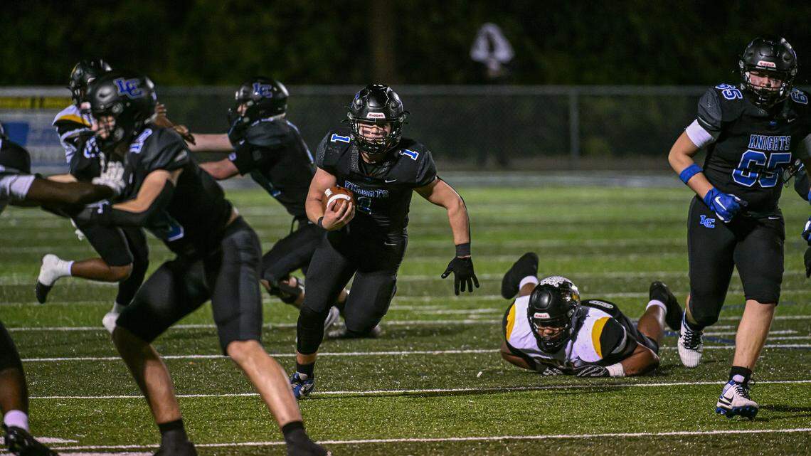 Lexington Catholic quarterback Brady Wasik (1), looks up field as he gets though Central’s line in the Knights’ 27-14 home win in a Class 3A second-round playoff game Friday.