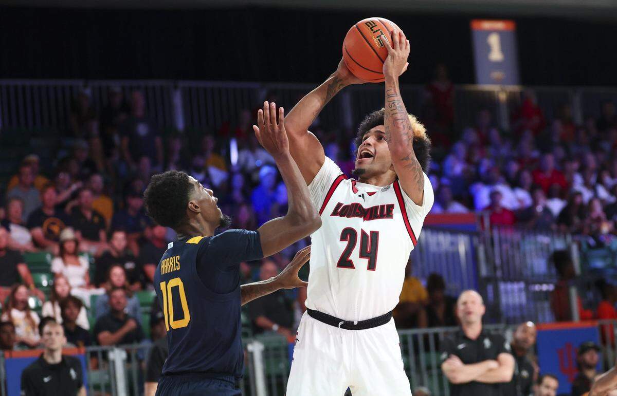 A transfer from Wisconsin, Louisville point guard Chucky Hepburn (24) leads the Cardinals in scoring and assists.