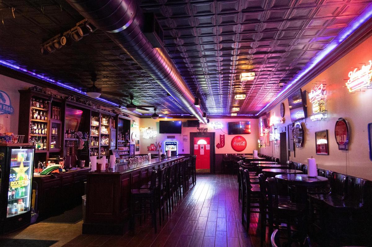 The bar lit up before opening at Pat’s Snack Bar in Manchester, Ky., Friday, April 15, 2022.