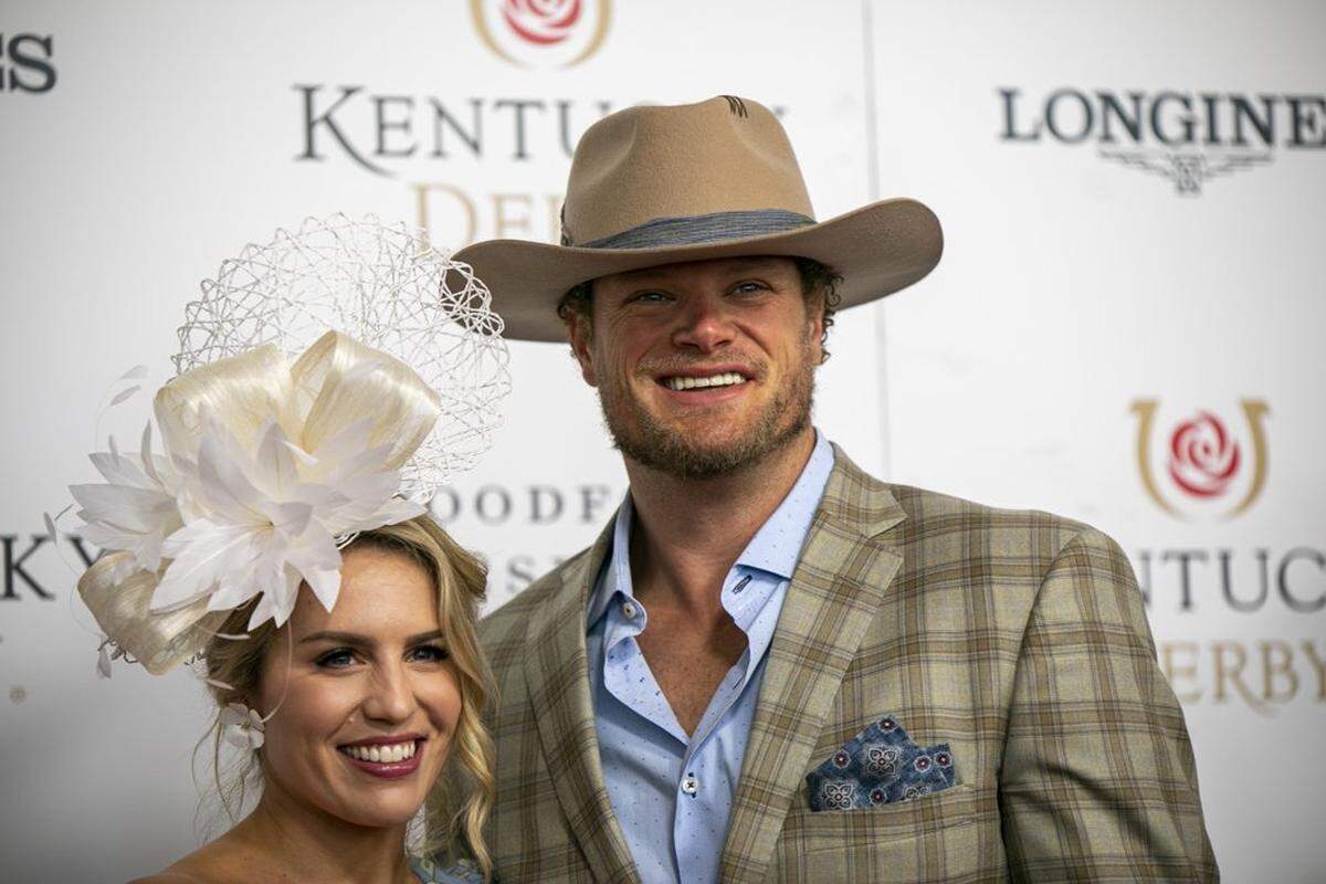 Former NFL Quarterback Eric Wood and Leslie Wood walk the red carpet at Churchill Downs in Louisville, Ky., Saturday, May 7, 2022.