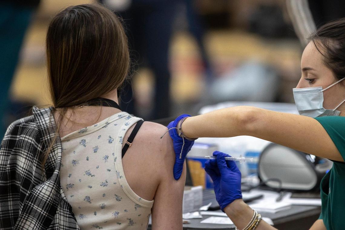 A Paul Laurence Dunbar student receives the COVID-19 vaccination at the high school in Lexington, Ky., on Tuesday, April 27, 2021. The vaccines were administered at six Lexington high schools Tuesday and were available for students age 16 and older, their families and school staff.