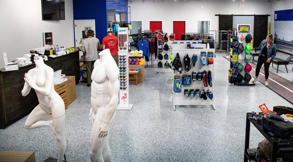 Store employees conduct quality checks, stock shelves, and arrange products for future purchase in preparation for the grand opening of J&H Running Co. at 189 Moore Dr. on May 22, 2025, in Lexington, Ky.