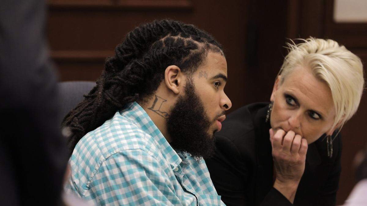 Quincinio Canada, one of two men on trial in the murder of U.S. Marine Cpl. Jonathan Price, spoke Wednesday with Karen Alexander, a mitigation specialist for his defense team.