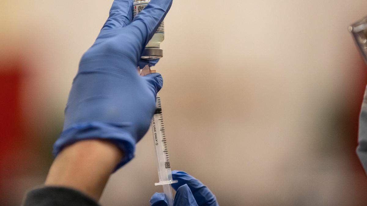 Kristen Parsons prepares a dose of the COVID-19 vaccine at a Lexington-Fayette County Health Department vaccination clinic at Consolidated Baptist Church in Lexington, Ky., on Wednesday, Feb. 3, 2021.