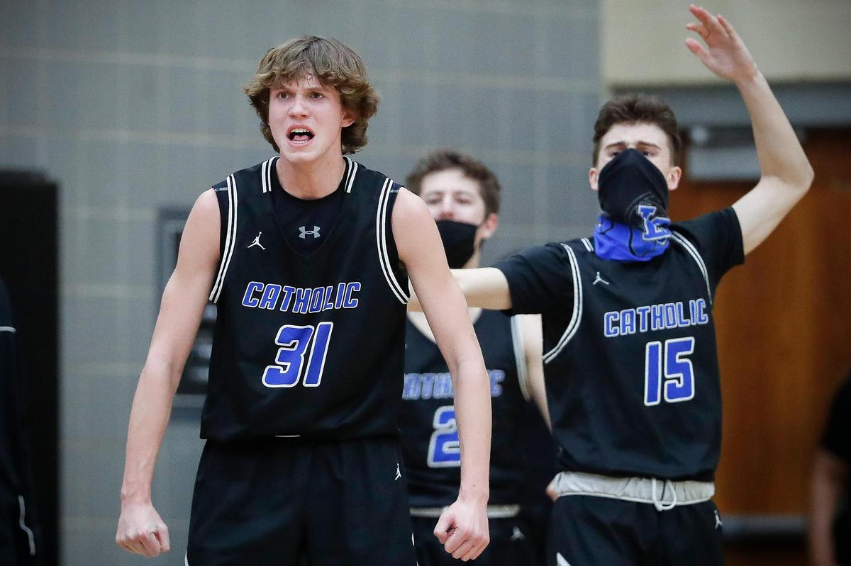Lexington Catholic’s Hudson Sparks (31) and Griffin Cameron (15) celebrated during Thursday’s game at Paul Laurence Dunbar. The Knights won 69-67.