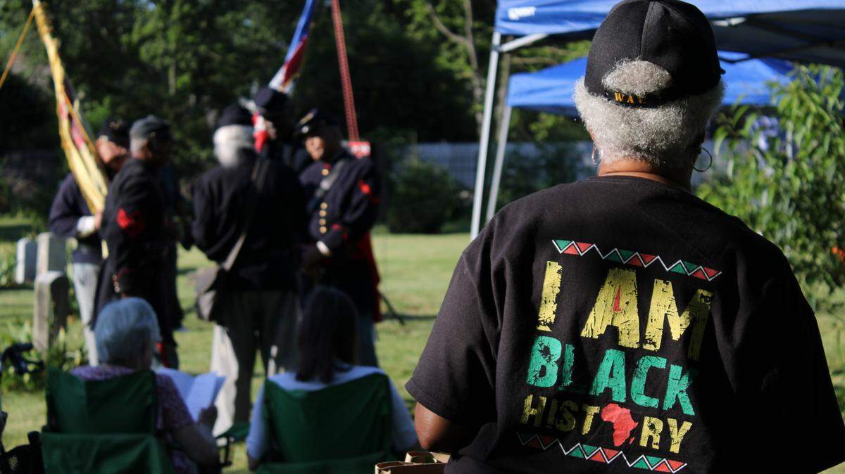 An attendee of the Juneteenth Jubilee watches the ceremony at African Cemetery No. 2 in Lexington, Kentucky on June 14, 2024.