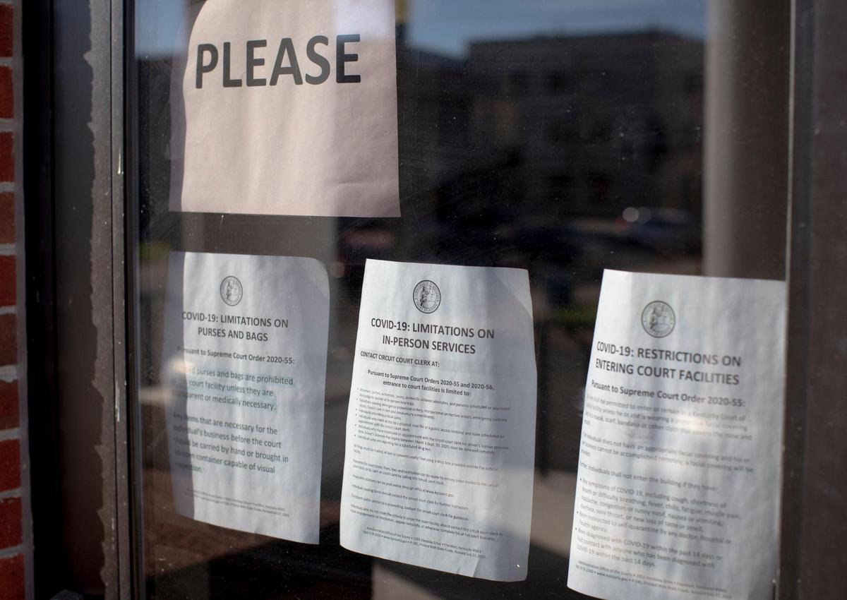 Signs on the front door tell visitors that court proceedings have switched from in-person to virtual at the Harrison County Judicial Center.