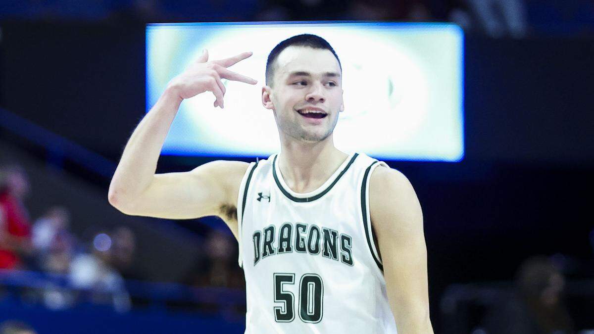 South Oldham’s Julian Miles (50) celebrates after he made a second-quarter 3-pointer. Miles contributed two of the Dragons’ near-state-tournament record 14 long-range shots and scored 14 points.