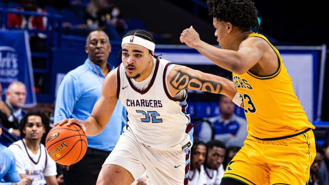 Jeffersontown’s Camron McDaniels (32) tries to break away from St. Xavier’s Jeremiah Jackson (23) during Wednesday’s first-round game in Rupp Arena. McDaniels scored eight of his 17 points in the final 1:05 of the game.