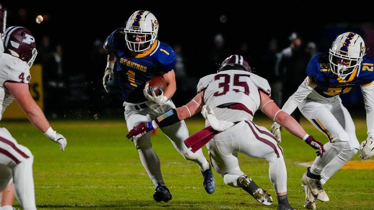 Sayre’s Charlie Slabaugh (1) tries to find yardage against Pikeville’s defense.