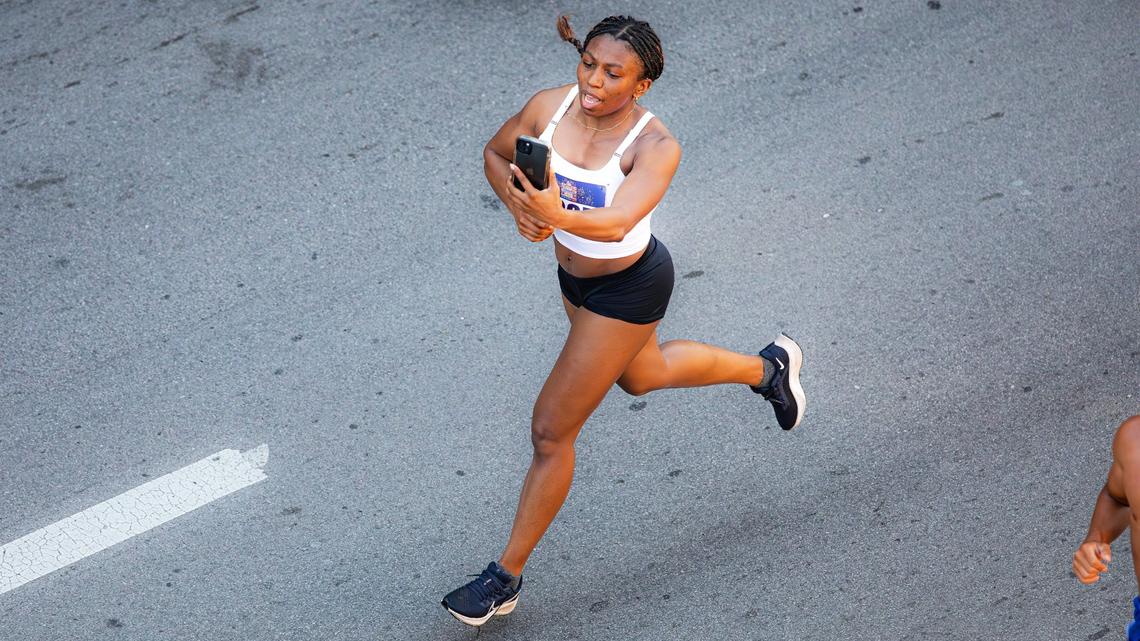 A participant records her finish during Friday’s race in downtown Lexington.